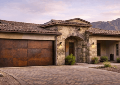 Rustic metal garage door on a stone home at dusk with mountains in the background